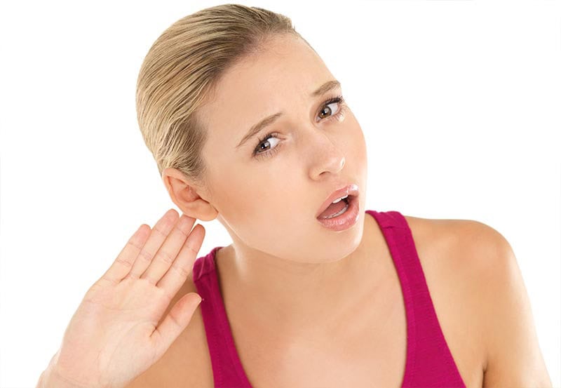 Woman listening closely for any furnace or heat pump repair sounds.