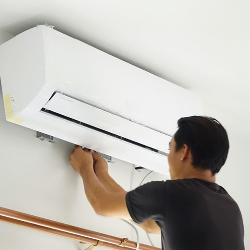 Video - 4 Amazing Benefits of Ductless Units. Image shows an HVAC professional working on a ductless unit mounted on home interior wall.